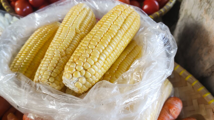 Texture of Sweet Corn Pile (Zea mays saccharata Sturt). Randomly stacked vegetables sold in Traditional Market. Textured Details. Fresh food ingredients. Wallpaper Backgrounds Photography Concepts