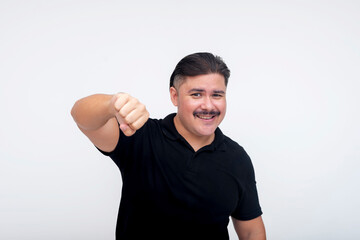 A middle aged man with a mustache smiling while offering a fist bump to someone. Acknowledging a...