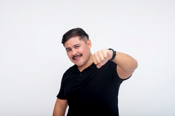 A middle aged man with a mustache smiling while offering a fist bump to someone. Acknowledging a...