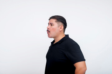 Side view of a middle aged man, of mixed race and with a mustache, whistling. Neutral facial expression. Set against a white background.