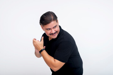 A wily man rubbing his hands his glee while looking around to see if the coast is clear. A...