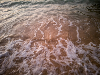 Nature background image of foamy wave on sand