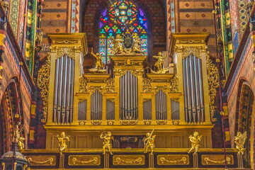 Colorful golden organ stained glass, St. Mary's Basilica, Krakow, Poland. Built first in 1300's and the interior in 1700's