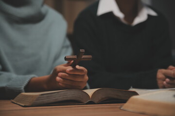 Obraz premium Christian group are praying to god with the bible and sharing the gospel. Concept of faith for god.