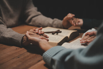 Christian group are praying to god with the bible and sharing the gospel. Concept of faith for god.