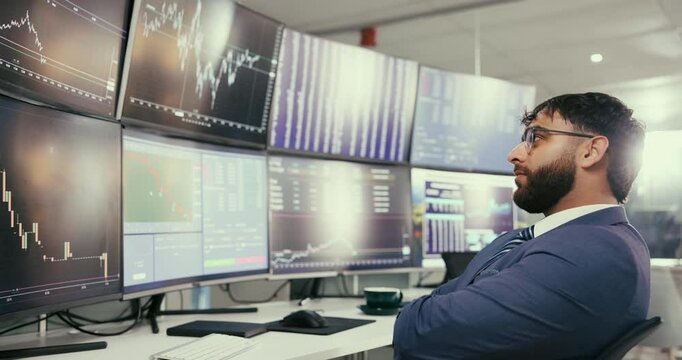 Young, businessman and broker with screen for stock market, trading or monitoring investments at office. Man, trader or investor with candlestick display, data or plummet for financial graph or chart