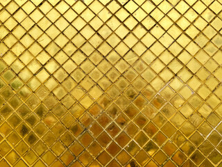 Beautiful gold Mozaic in diamond shape as a wall finishes in golden pagoda and temples in Thailand. Seamless reflective golden diamond mozaic texture.