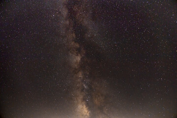 A stunning view of the Milky Way galaxy arching over Joshua Tree National Park, California,...
