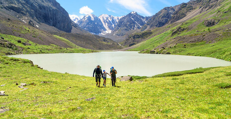 father and two children hiking in the mountains