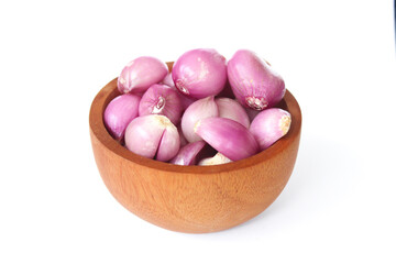 Red Onion in a wooden bowl isolated on white background.