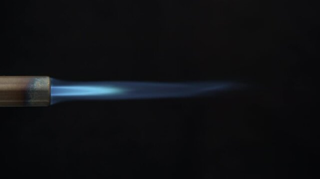 Long jet flame coming out of a burner pipe.