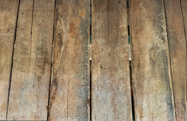 Close up of rustic rough solid wood decking panel, weathered and decayed solid wood decking.
