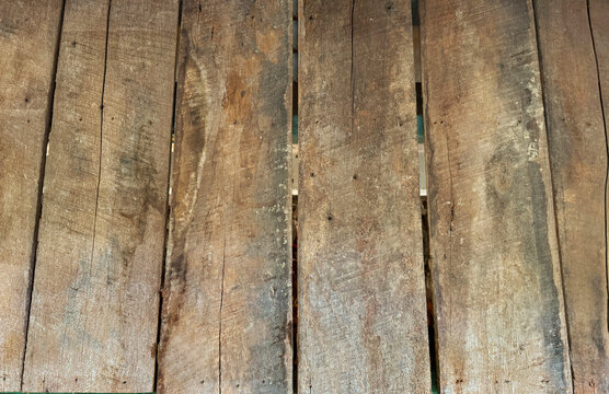 Close up of rustic rough solid wood decking panel, weathered and decayed solid wood decking.