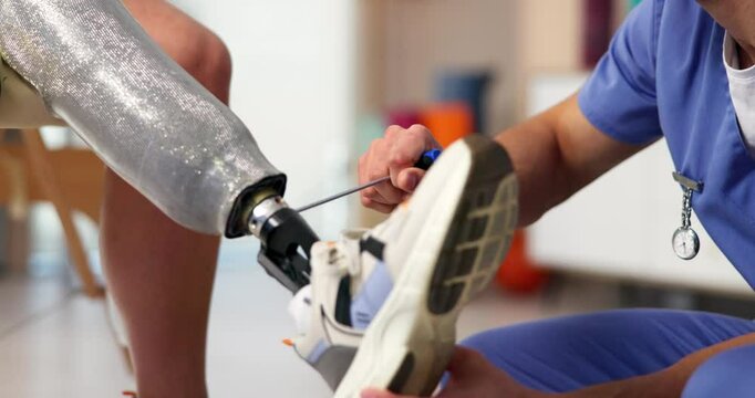 Adjust, prosthetic or screwdriver with patient and physiotherapist in office for recovery or rehabilitation. Healthcare, help or medical with amputee person and man in physical therapy clinic