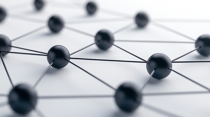 Close-up view of interconnected black spheres on a light background, representing networking, technology, and abstract connections.