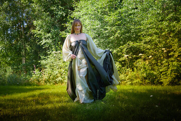 Beautiful dryad or fairy in nature. Pagan spirit of forest. Environmental friendliness and caring...