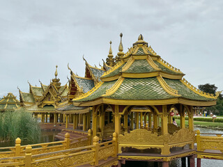 Obraz premium Amazing famous Pavilion of the Enlightened, a green temple complex in Muang boran Ancient city, Samut Prakan, Bangkok, Thailand. Surrounded by a lake.