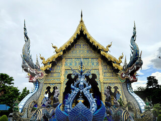 The famous Blue temple at Chiang Rai, Thailand, or Wat Rong Suea Ten in Thai. This temple hosts many Buddhist ornaments painted in all blue and gold colors.