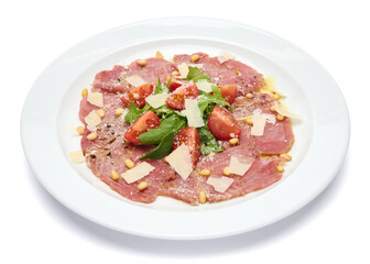 cooking tuna carpaccio - cherry tomato pieces on a plate with raw tuna fillet slices