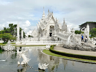 Fototapeta premium The famous White temple at Chiang Rai, Thailand, or Wat Rong Khun in Thai. White temple with its authentic Buddhist ornaments and engraving covered in all white paint.