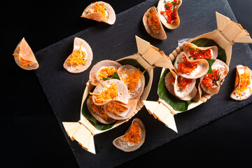 Thai street food dessert Thai crispy crepe Khanom bueang on black background with copy space