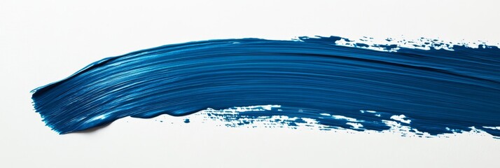 A vibrant blue paint stroke elegantly glides across a white canvas, highlighting the artistry and craftsmanship involved in hand-painted techniques