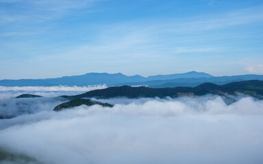 Fototapeta premium Landscape image of mountains peak with sea of clouds and blue sky