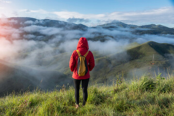 hikers backpacks standing on top of a mountain and enjoying nature view