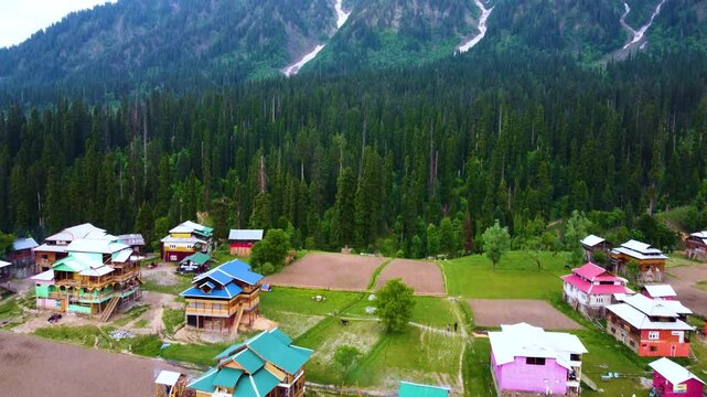 Breathtaking view of Arang Kel landscape with colorful houses in Kashmir, Pakistan. Drone shot.