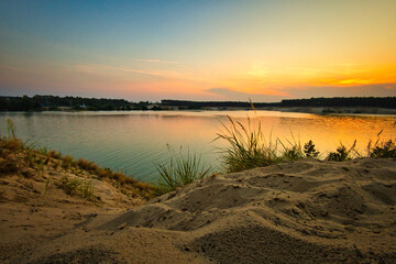 See im Abendrot - Sunset - Landscape - Beautiful Sunset scene over the lake and silhouette hills in the background - Sunrise over sea - Colorful - Reed - Clouds - Sky - Sundown - Sun	