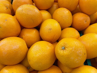 Orange fruit in the market, close up of a pile of oranges