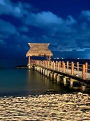 Mexico boardwalk to ocean at night 
