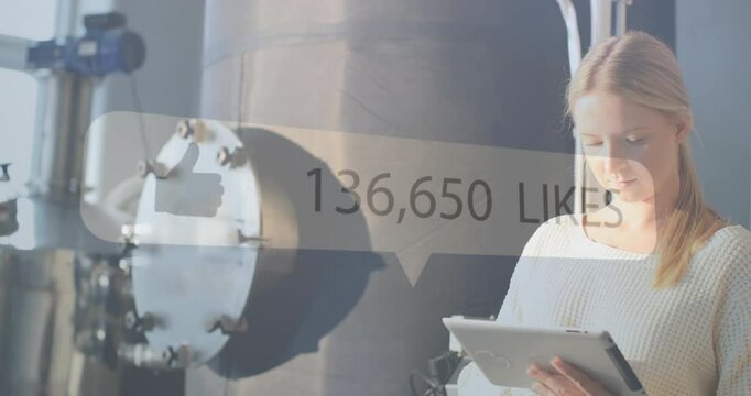 Using tablet, woman in industrial setting with 176,806 likes animation over