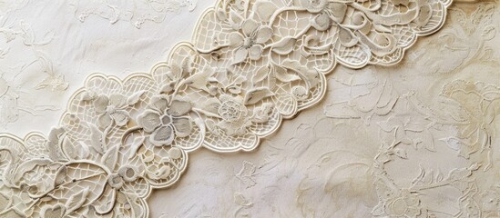 Gray lace on a beige paper background. Copy space image. Place for adding text and design