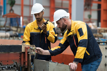 Manufacturing, warehouse concept. Group of male engineer factory worker working and inspecting...
