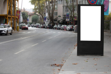 Vertical blank white billboard on the roadside. Poster banner. Billboard in the city center mock up.	