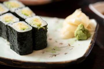 Close up of sushi roll on small plate