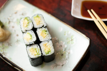 Overhead looking down on sushi roll on small plate