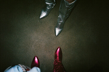 Overhead shot of silver and red cowboy boots