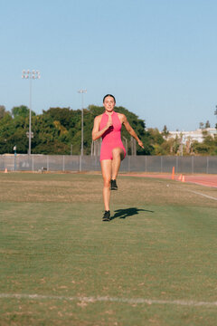 Female athlete doing warm up exercise on grass
