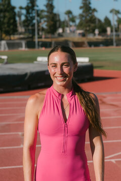 Smiling female athlete after track workout