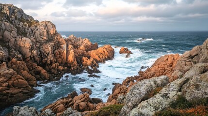 Obraz premium Dramatic ocean waves crash against rocky cliffs, creating a stunning seascape.