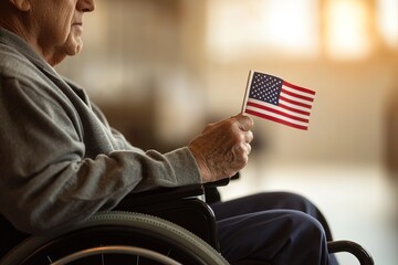 Elderly veteran in wheelchair holds small American flag