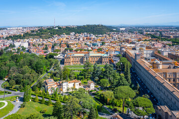 Obraz premium Visitors enjoy the serene beauty of the Vatican Museums and Gardens, surrounded by lush greenery and historical architecture, showcasing breathtaking views of the cityscape of Rome.