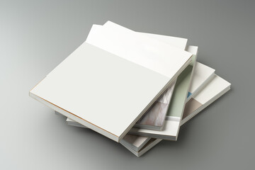 A stack of blank notebooks arranged neatly on a simple grey background
