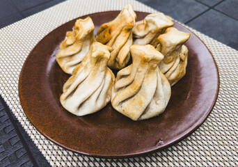 Fried khinkali in a plate on the table