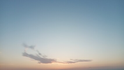 Graceful cirrus cloud drifting in the sky during a breathtaking sunset