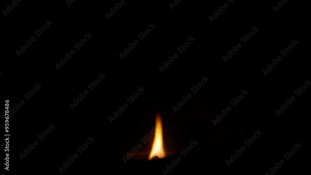 Poster lit candle with a soft glowing flame in a dark background, creating a serene and quiet atmosphere