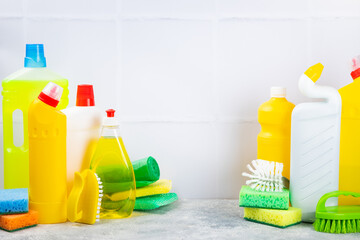 Cleaning service concept.Home cleaning product on a pink background. Bucket with household chemicals. cleaning supplies for home or office space.Early spring regular cleaning. Copy space