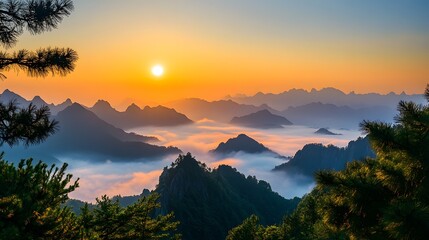 Obraz premium A breathtaking sunset view over a misty mountain range, creating a serene and tranquil atmosphere.